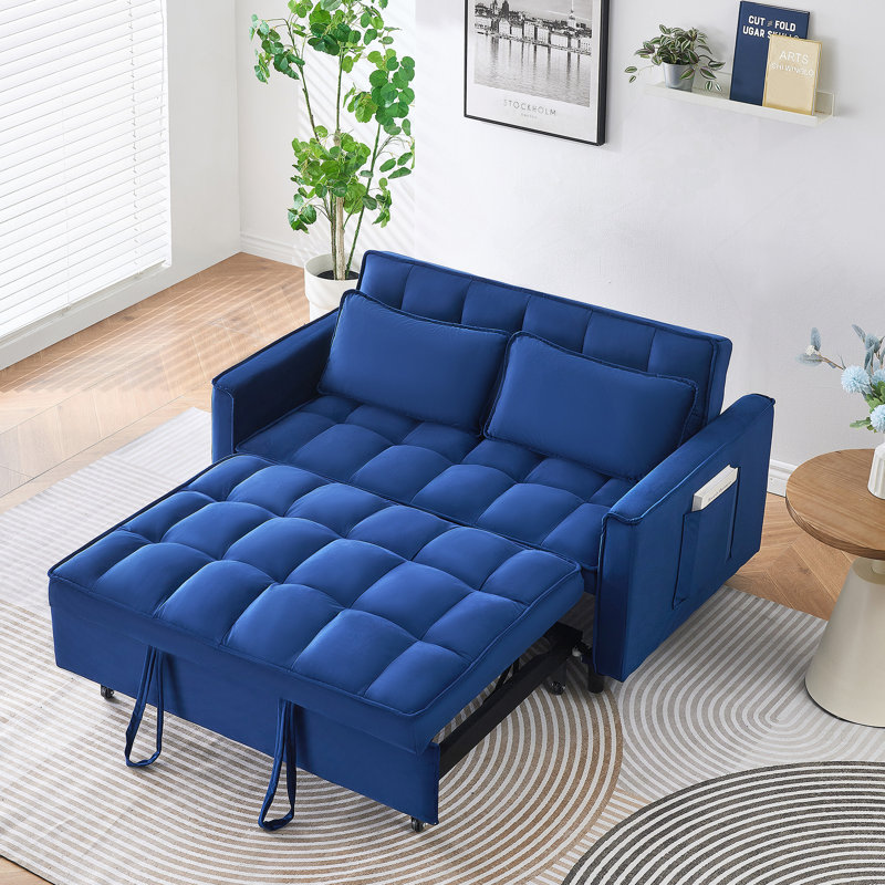 Exquis canapé-lit avec poches et conversion trois-en-un, offrant élégance et commodité pour des espaces de vie confortables.
