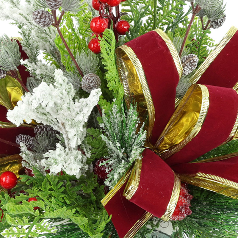 Festive holiday arrangement with greens and Berries