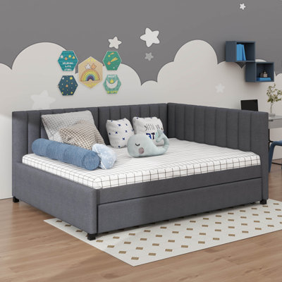 A Full-Sized Upholstered Daybed Incorporating A Built-In Trundle Bed
