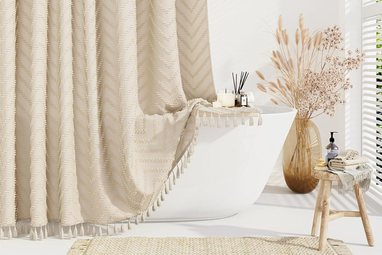beige shower curtain over a white bathtub