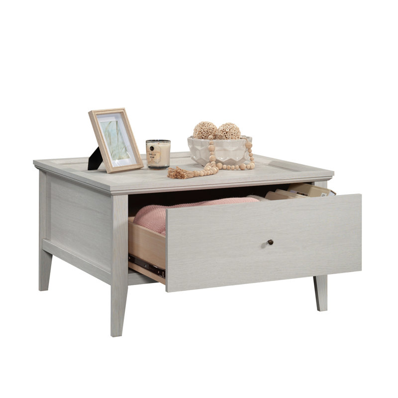 Table basse grise avec une finition latérale, un motif hexagonal et un grand espace convenant à un usage domestique