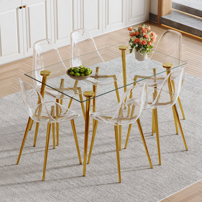 Ensemble de table à manger moderne et luxueux avec plateau en verre trempé et chaises en plastique transparent pour une expérience de cuisine à la maison confortable