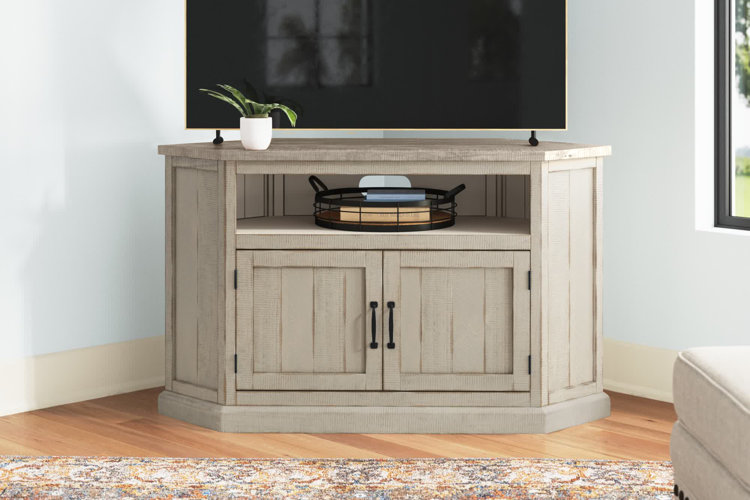 A rustic corner tv stand with a set of cabinets under an open shelf.
