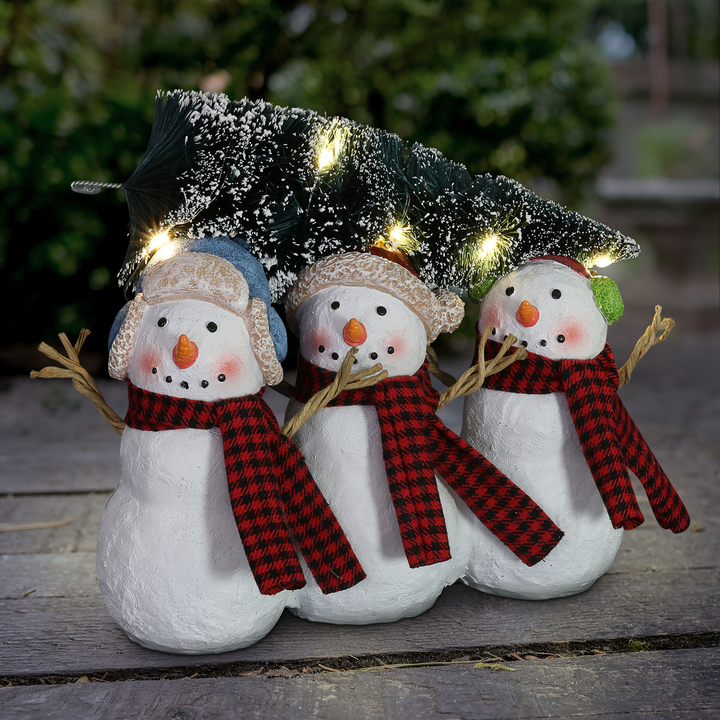 Exhart Three Snowmen Carrying A Led Christmas Tree Statue On A Battery 