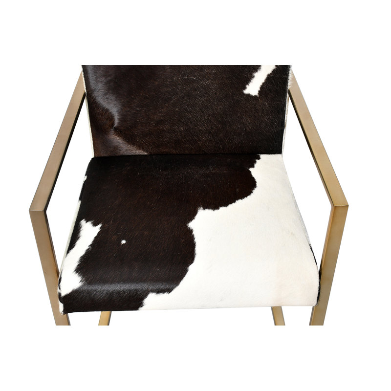 A GOLD STAINLESS STEEL CHAIR WITH BLACK & WHITE COW LEATHER