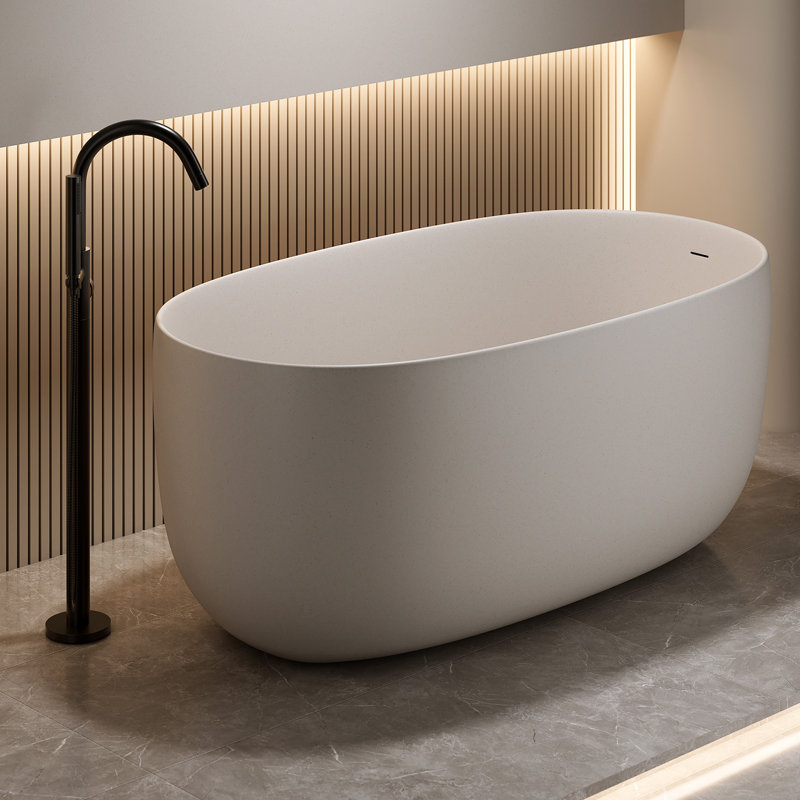 Baignoire îlot en résine effet pierre beige, lisse et arrondie, offrant une excellente isolation pour un bain relaxant. Matériau résistant à l'usure et facile à nettoyer.