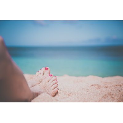 Woman Feet on Tropical Sand Beach by Onfokus