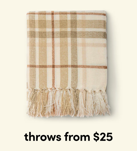 Folded tan and cream plaid throw blanket with tassel fringe detail, throws from $25.