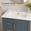 Meuble-lavabo bleu intégré en céramique de 24 pouces avec une porte à trois tiroirs et un meuble-lavabo spécialement conçu pour les petites salles de bain.