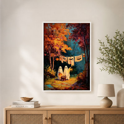 Tableau automnal sur toile représentant deux fantômes, un panier de citrouilles et des chauves-souris, avec cadre flottant, prêt à accrocher.