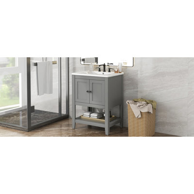 Meuble-lavabo gris avec construction en bois massif, lavabo en céramique et nombreuses tablettes de meuble-lavabo élégant