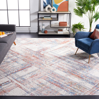 Tapis géométrique ivoire / rouille / bleu