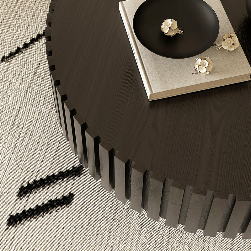 Table basse ronde avec relief fabriqué à la main et piédestal robuste, parfaite pour les salons modernes et élégants