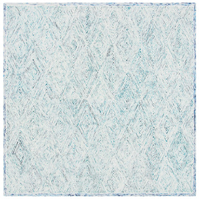 Tapis géométrique bleu / ivoire en laine touffetée à la main de la personne