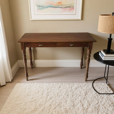 A sturdy teak desk with retro metal handles