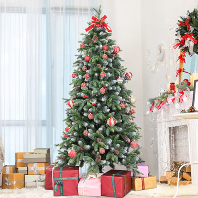 Arbre de Noël artificiel givré avec baies rouges et pomme de pin