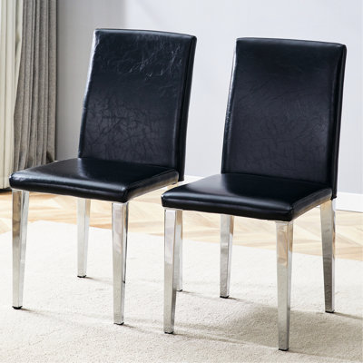 Deux chaises de salle à manger en polyuréthane noir avec des pieds en métal argenté, un style simple et à la mode, un corps confortable - taille convenable, un assemblage facile de 2 tapis exquis à la mode, un coussin souple, des pieds de corrosion
