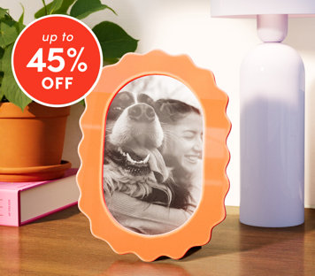 Decor up to 45% off featuring orange wavy picture frame with lamp and plant on desk
