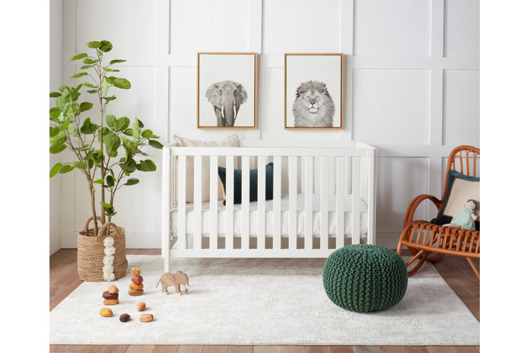 white area rug in nursery under a white wood crib