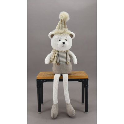 Figurine d'ours assis portant un chapeau
