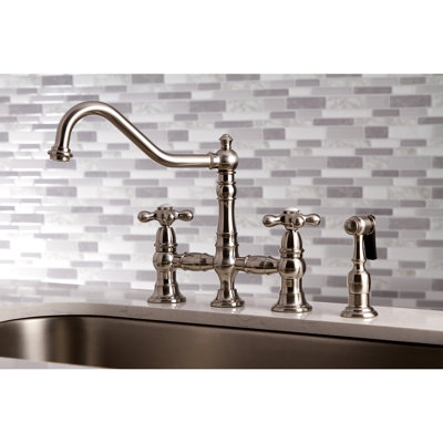 Kingston Brass Restoration Two-Handle 4-Hole Deck Mount Bridge Kitchen Faucet with Brass Side Sprayer