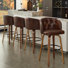 Swivel Bar Stool With Curved Wood Legs, Upholstered Tufted Back, And Nailhead Trim