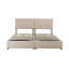 Très grand lit avec revêtement beige et grand espace de rangement rembourré