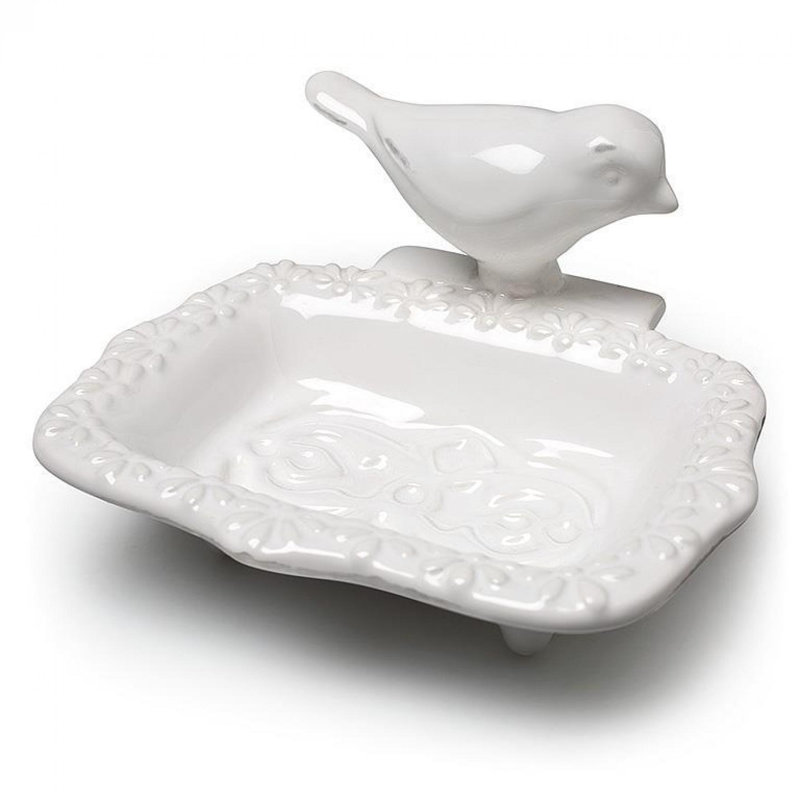 Oiseau sur un porte-savon rectangulaire