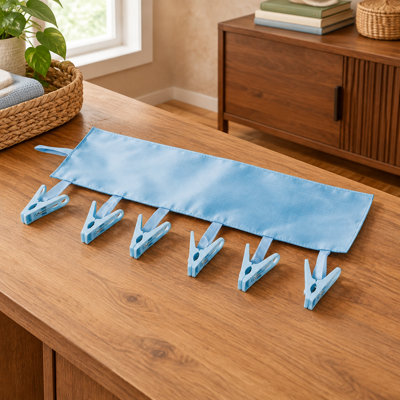 This adjustable blue folding clothes hanger uses fabric and PP materials with 6 clips, combining a compact travel design with bathroom laundry use.