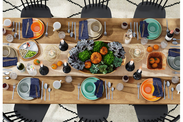 side table with pumpkins, candles, and garland