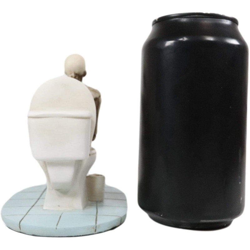 Squelette constipé Ebros, éternelle vie après la mort, assis sur une cuvette de toilette alors qu'il parcourait son téléphone portable Figurine Macabre Ossuary