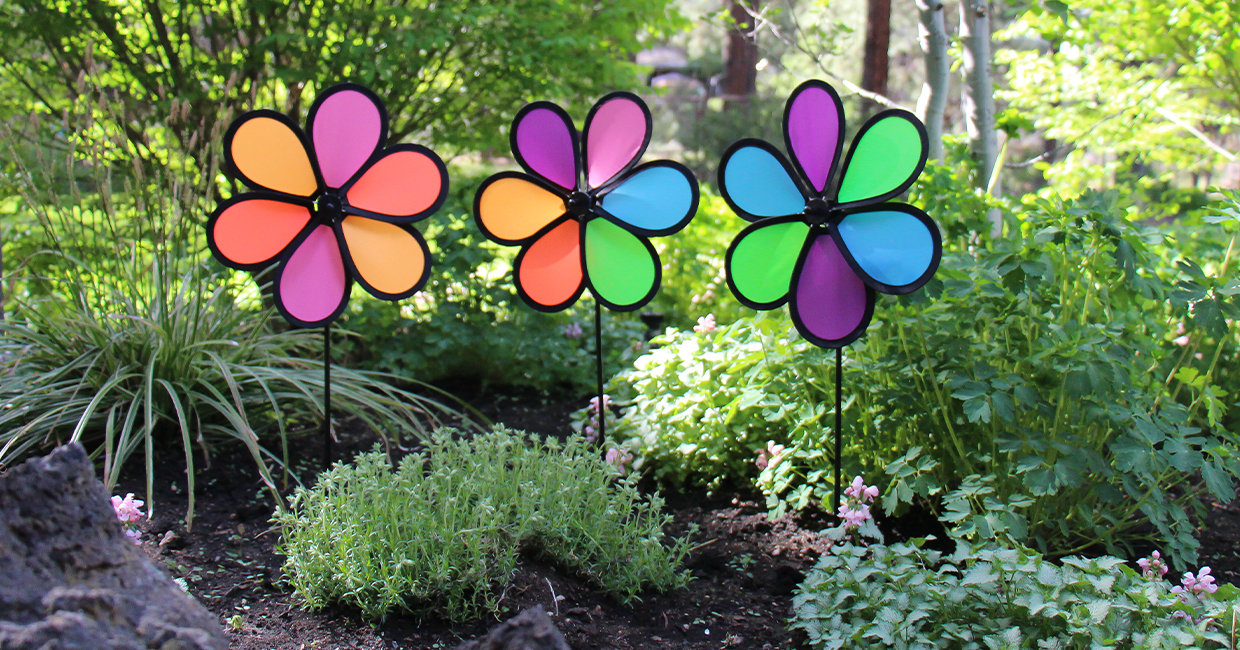 Three colorful 10-inch Neon Spinners in a verdant garden 