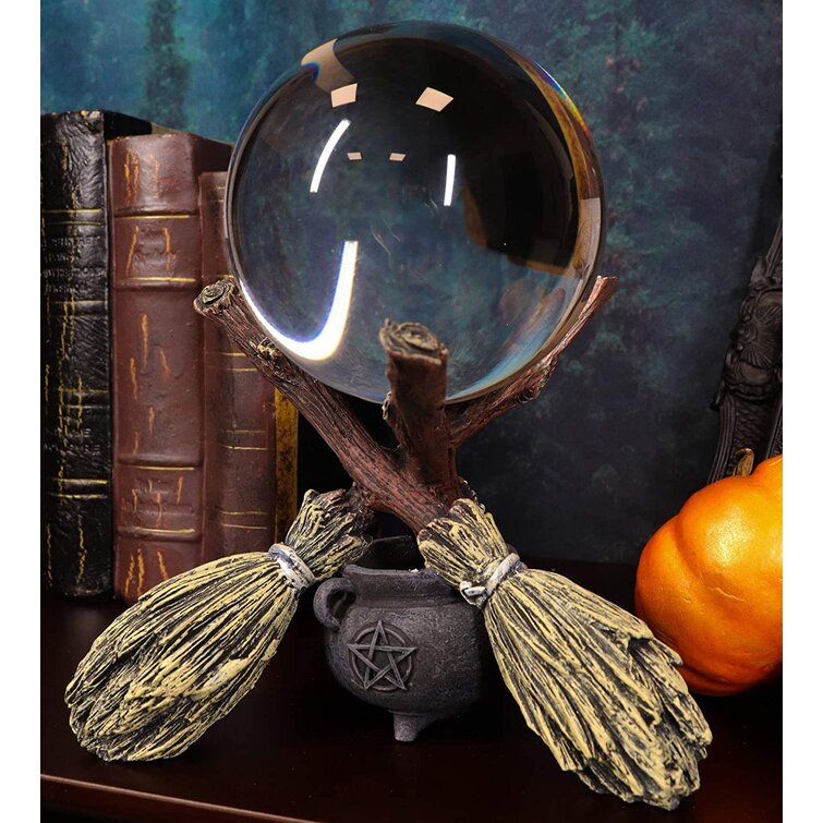 The Holiday Aisle® Wicca Psychic Fortune Teller Scrying Witch Crystal Glass Gazing Ball On Broomsticks And Potion Cauldron Figurine 8" H Witchcraft Wiccan Witches Decor Halloween Sculpture Decorative