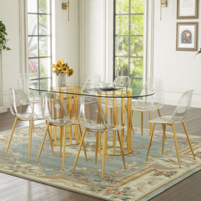 Ensemble de table et de chaises, table de salle à manger ovale en verre trempé de 71 pouces, double lumière dorée de style luxueux. Jumelé avec 8 chaises en plastique transparent avec des pieds en métal doré.