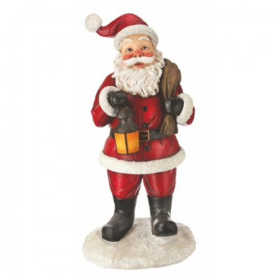 Statue de père Noël debout avec lanterne