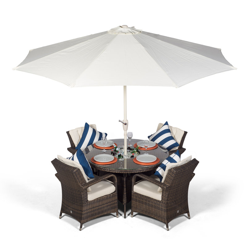 Karas 4 - Person Wicker Patio Dining Set with Round Table , Cushions Included, Brown