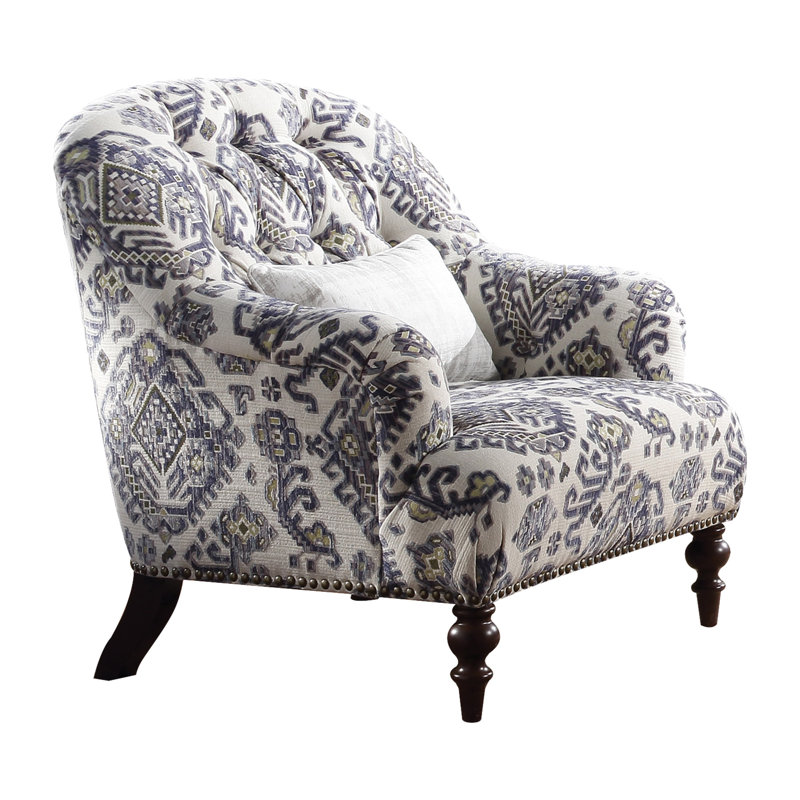 Fauteuil en tissu à motifs avec 1 coussin, garnissage en plumes et mousse dans l'assise, dossier boutonné seulement, garniture cloutée à la base, coussin d'assise ferme, sans accoudoirs, pieds tournés en bois chocolat, tissu multicolore.