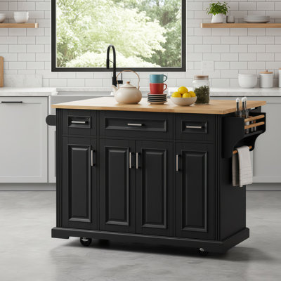 Grand îlot de cuisine en bois d'hévéa avec un comptoir pliant à texture en relief. Mouvement à quatre roues, plusieurs portes et tiroirs pour un rangement maximal.
