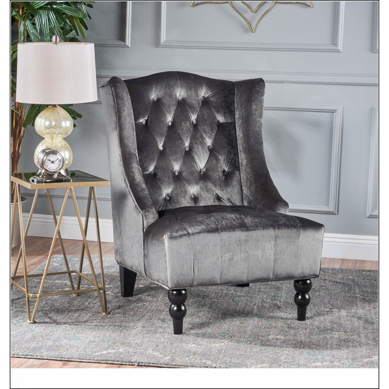 Fauteuil club à dossier haut avec dossier à oreilles et coutures en losange capitonnées pour un confort et un style modernes