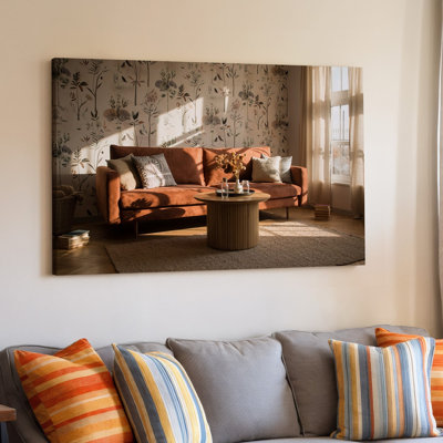 Toile, une scène de salon confortable avec un canapé d'art mural chaleureux aux tons terreux orné de divers coussins à motifs fixés contre une toile d'art mural