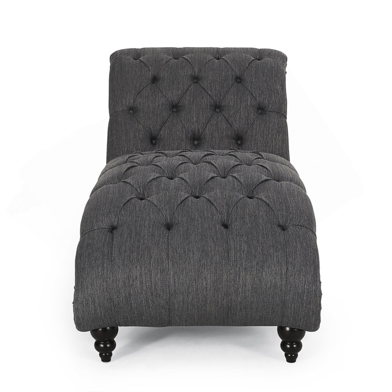 Chaise longue élégante avec un design tout en courbes, un capitonnage à boutons et des pieds en bois de bouleau pour un confort et un style ultimes.
