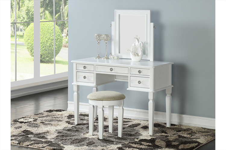 a white makeup vanity with crystal drawer pulls