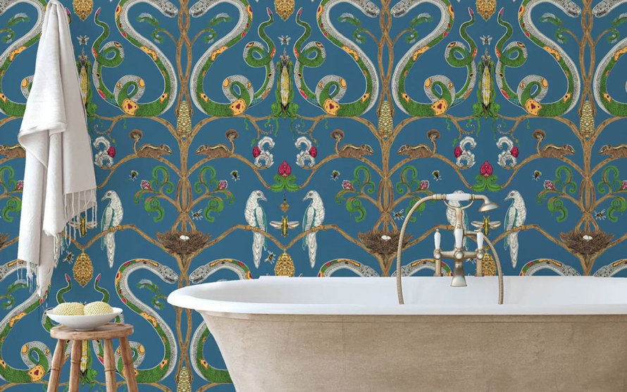 Bathroom featuring blue wallpaper with snakes, birds, and squirrels.