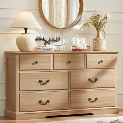 Commode de style champêtre de 137 cm (54 po) à 7 tiroirs avec poignées rustiques, structure en bois d'ingénierie et base épaisse.
