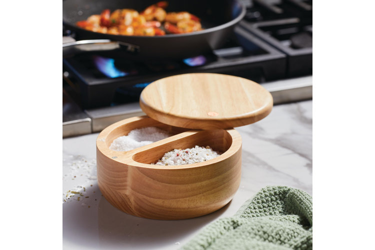 wooden salt cellar with divider snd lid on countertop for cooking