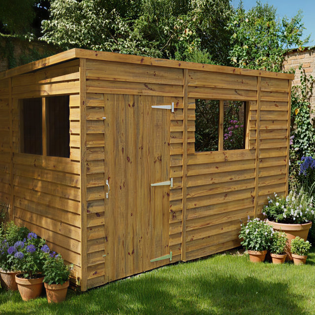 Wooden shed with windows and double doors.