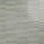 Sage green ceramic picket wall tiles with a glossy finish in an interlocking pattern.