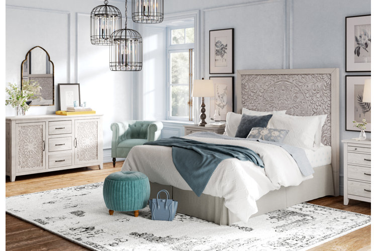 Bedroom with a gray wood panel bed, white sheets, and blue room accents.