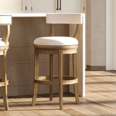 Tabouret de bar avec siège d'une hauteur de 31 pouces, finition pacane, siège à retour automatique à 180 degrés, structure en bois recouvert de similicuir gris avec dossier ouvert, garniture cloutée entourant les pieds incurvés, tabouret de 31 po