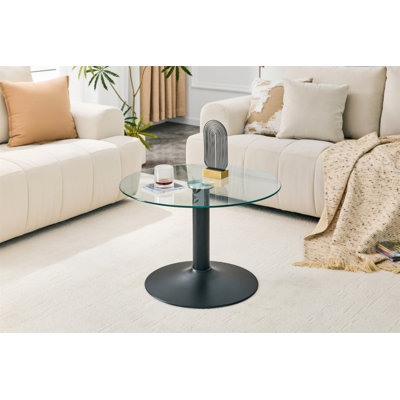 Table basse ronde en verre trempé de 27,5 pouces de diamètre. 17,7 pouces de haut, soutenu par une base en métal noir, avec un bord de luxe léger.